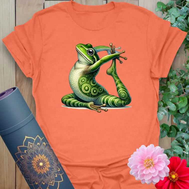Vibrant orange t-shirt with full-color meditating frog illustration for lighthearted, mindful living.
