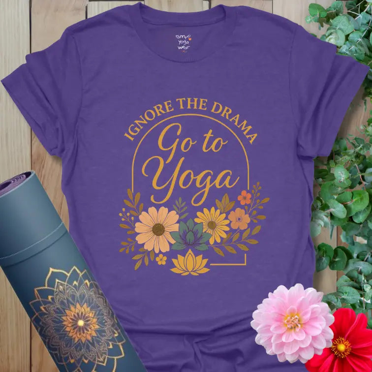Floral arch “Ignore the Drama – Go to Yoga” design on a heather purple tee, soft script lettering with warm vintage tones.