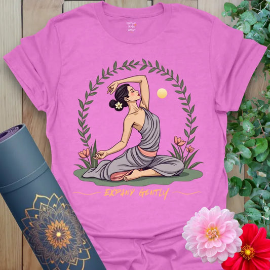 Radiant orchid-colored yoga tee with yogini in graceful yoga pose, floral wreath, and sun symbolizing gentle expansion.