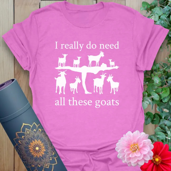 Radiant orchid-colored yoga tee with playful goats balancing on yogi artwork celebrating light-hearted mindfulness.