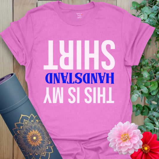 Radiant orchid-colored yoga tee with playful upside-down handstand quote for light-hearted soulful expression.