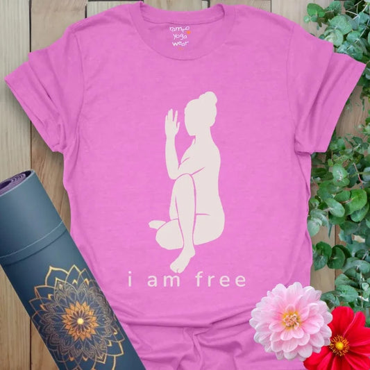 Heather Radiant Orchid I Am Free T-Shirt with yogi in seated twist pose and affirmation text “I Am Free.” Vibrant yoga lifestyle tee for empowerment.