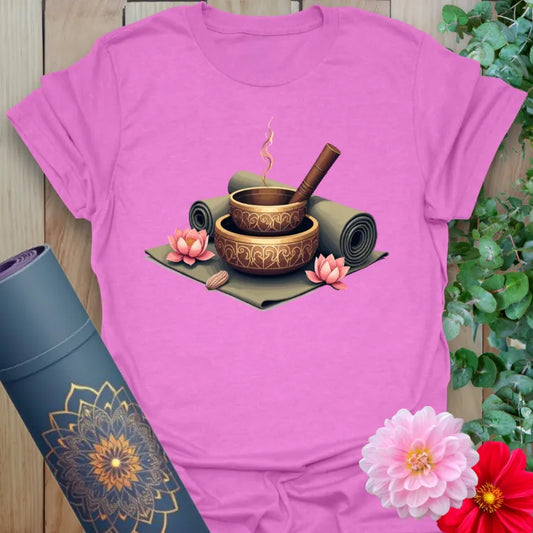Radiant orchid-colored yoga tee with sacred singing bowl and meditation mat design celebrating mindful presence and peaceful rituals.
