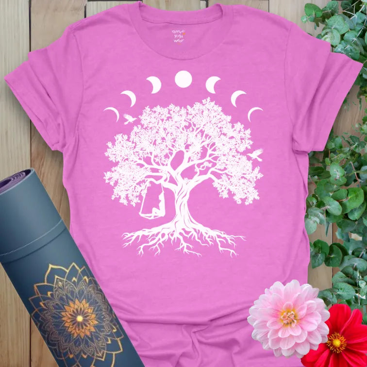 Radiant orchid-colored yoga tee with celestial tree and swing artwork celebrating joyful mindful living and cosmic flow.