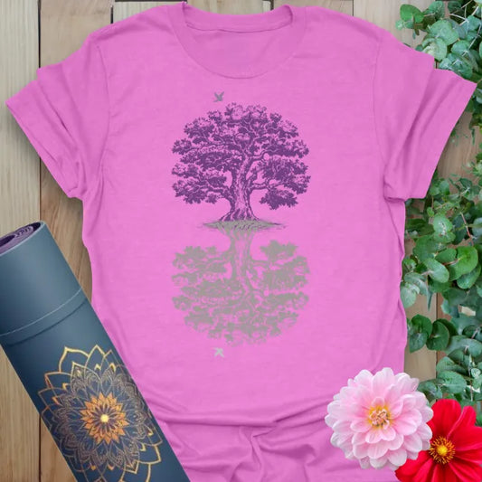 Radiant orchid-colored yoga tee with mystical mirrored tree artwork celebrating balance, reflection, and soulful strength.