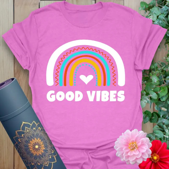 Radiant orchid-colored tee with playful rainbow heart and “Good Vibes” affirmation for soulful, fun movement.