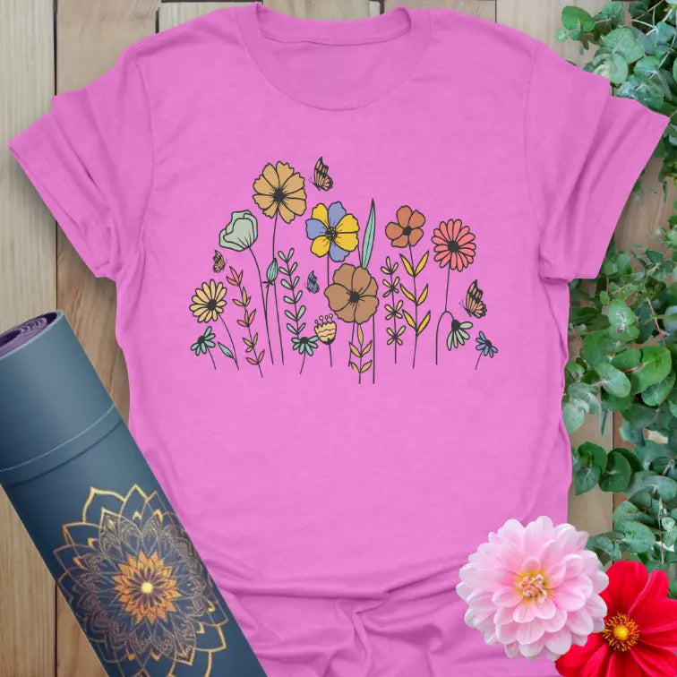 Radiant orchid-colored tee with blooming botanical design and fluttering butterflies for mindful expression.