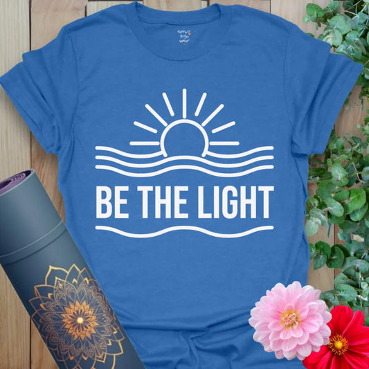 Blue Be The Light Shirt with white sunrise line art and uplifting vibe.