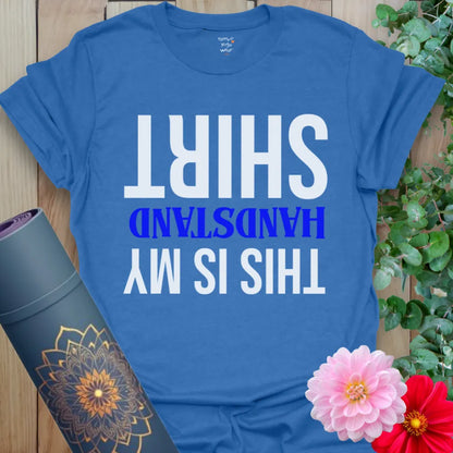 Soft cotton unisex yoga t-shirt featuring playful upside-down "This Is My Handstand Shirt" graphic for joyful mindful movement.