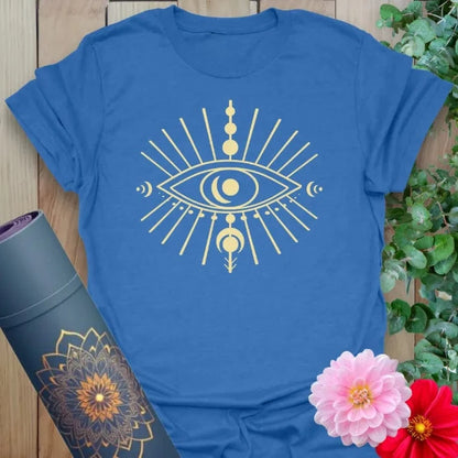 Soft cotton unisex yoga t-shirt featuring celestial eye design with moon phases and radiant energy beams for mindful, cosmic living.