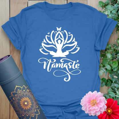 Soft cotton unisex yoga t-shirt featuring blooming lotus, meditating figure, and "Namaste" script symbolizing gratitude and mindful connection.