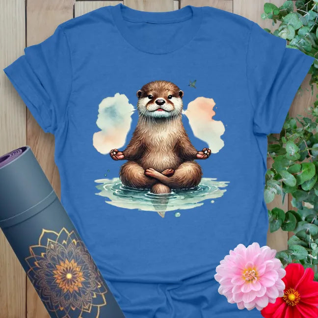 Soft cotton unisex yoga t-shirt featuring meditating otter illustration with serene water and cloud backdrop for mindful, playful living.