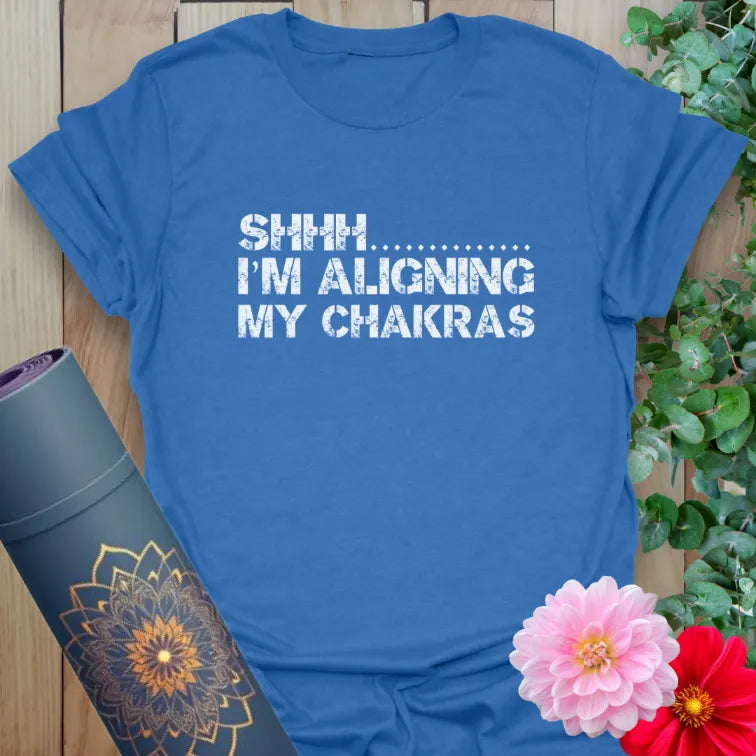 Soft cotton unisex yoga t-shirt featuring playful "Shhh... I’m Aligning My Chakras" quote for mindful, soulful living.