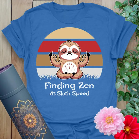 Soft cotton unisex yoga t-shirt featuring adorable meditating sloth and retro sunset with "Finding Zen at Sloth Speed" quote for mindful, relaxed living.