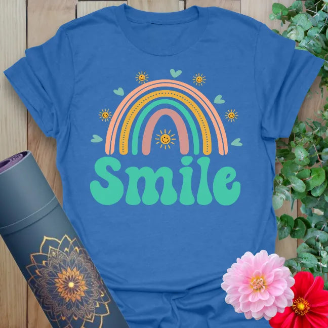 Soft cotton unisex yoga t-shirt featuring colorful rainbow, hearts, and bold "Smile" text inspiring joy and soulful living.