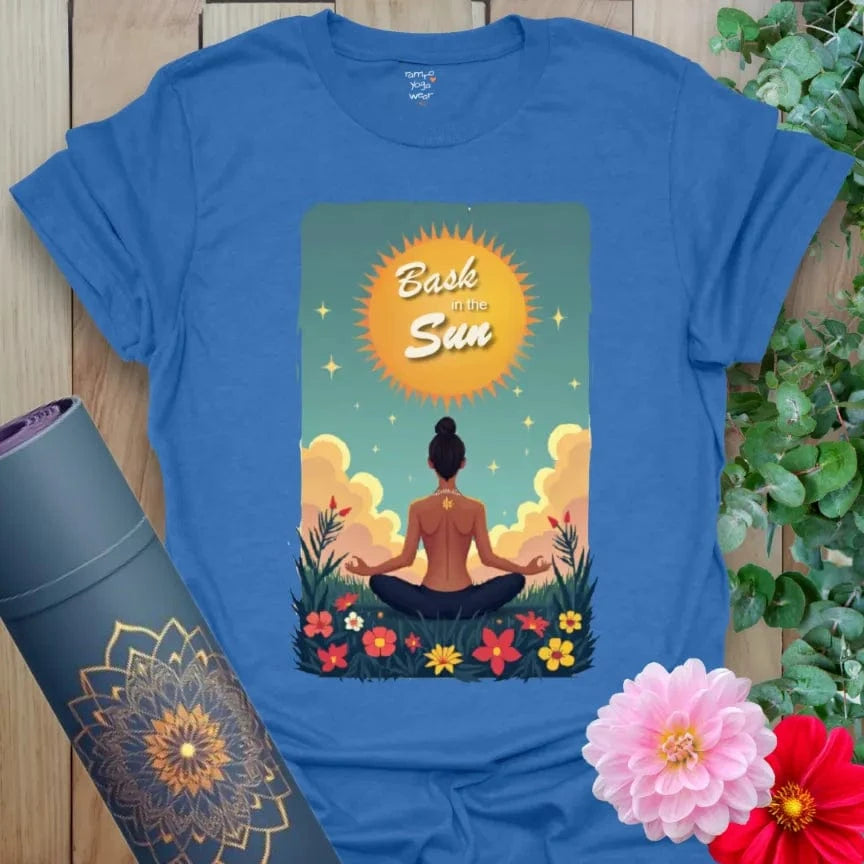 Soft cotton yoga t-shirt with meditating figure under a glowing sunrise and “Bask in the Sun” mantra, ideal for peaceful movement.