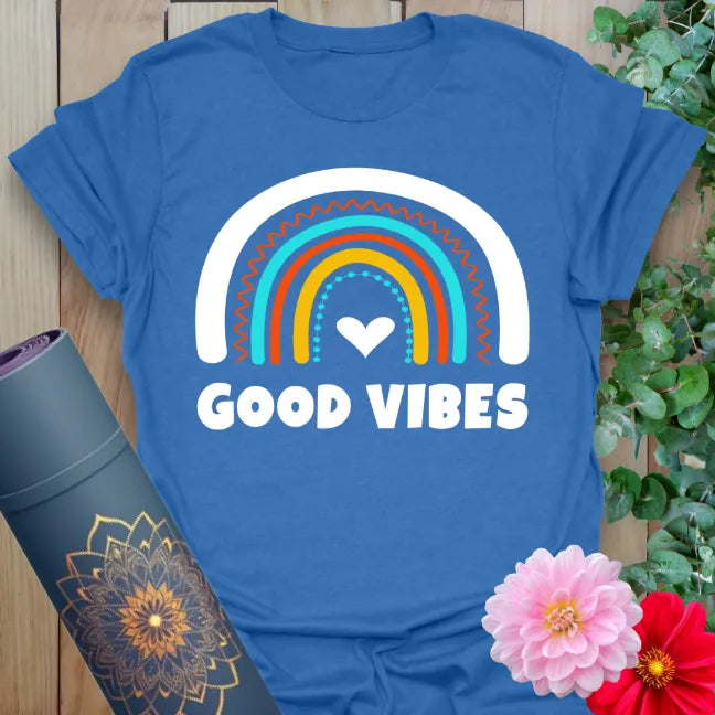 Soft cotton yoga tee featuring colorful hand-drawn rainbow and bold “Good Vibes” text for cheerful spiritual style.