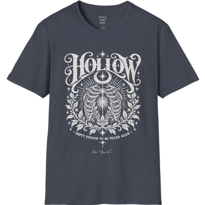 Symbolic ribcage engraving with a single glowing light at the center, crescent moon behind. Hollow T-Shirt flat lay is a Gildan 64000 and the color is Heather Navy.