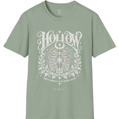 Symbolic ribcage engraving with a single glowing light at the center, crescent moon behind. Hollow T-Shirt flat lay is a Gildan 64000 and the color is Sage.