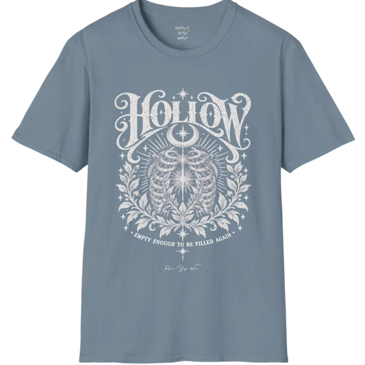 Symbolic ribcage engraving with a single glowing light at the center, crescent moon behind. Hollow T-Shirt flat lay is a Gildan 64000 and the color is Stone Blue.