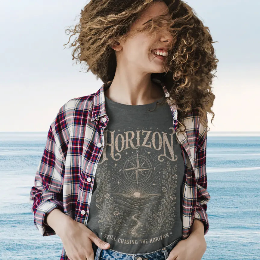 Person wearing Horizon Dark Heather Grey colored sacred yoga shirt at a windy beach — Sacred Thread collection by Ramro Yoga Wear