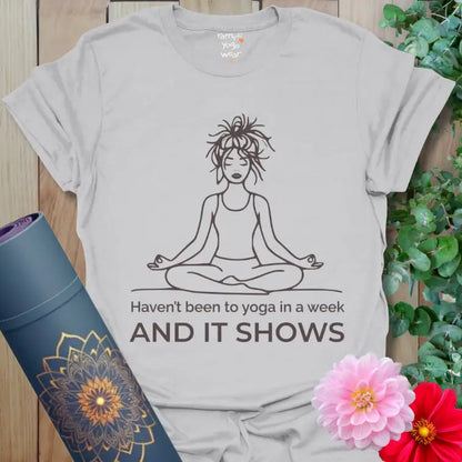 Ice Grey It Shows T-Shirt with humorous “Haven’t been to yoga in a week and it shows” text and relaxed yogi line drawing.