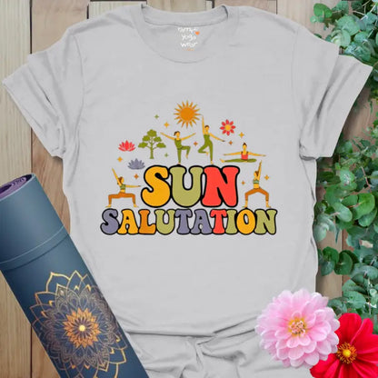 Ice Grey Sun Salutation T-Shirt with vibrant sunrise tones and playful yoga poses. A soft neutral tee symbolizing calm morning energy.