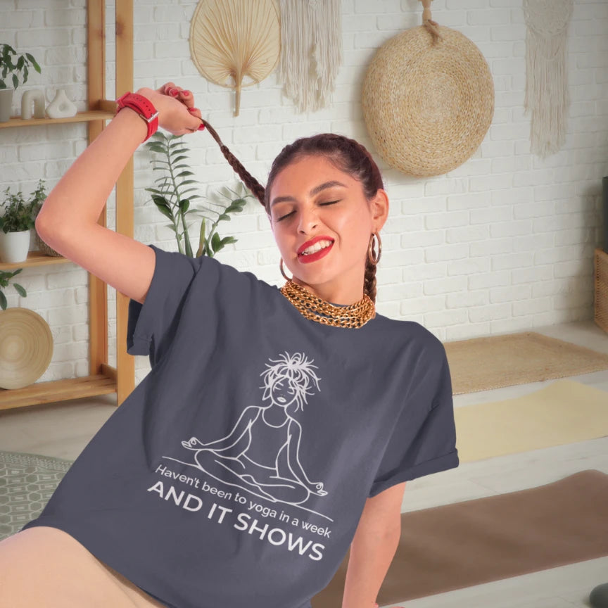 It Shows T-Shirt lifestyle image featuring woman sitting indoors, showcasing relaxed and mindful everyday yoga style.