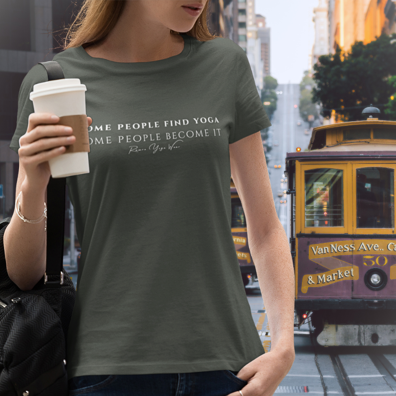  Woman wearing Known Military Green yoga teacher gift tee on a San Francisco street with cable car — Yoga Teacher Gifts collection by Ramro Yoga Wear