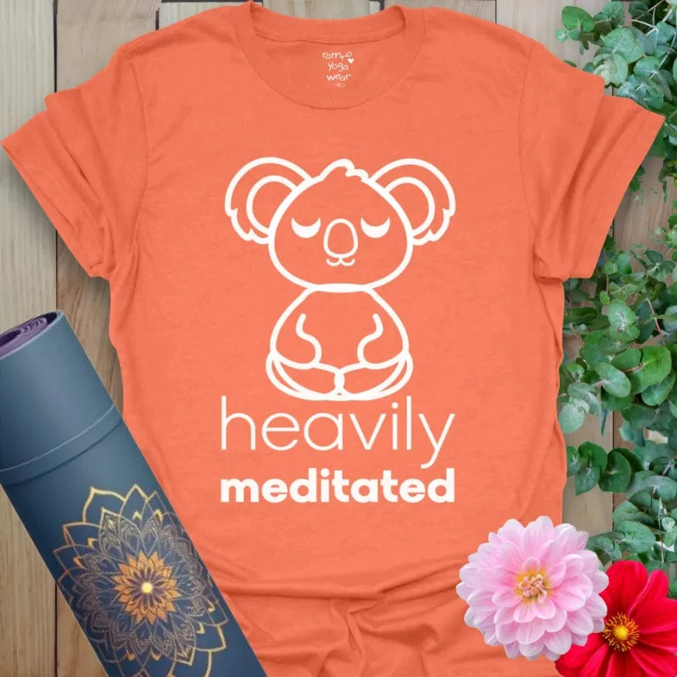 Vibrant orange yoga t-shirt showcasing peaceful koala meditation design and playful mindfulness message.