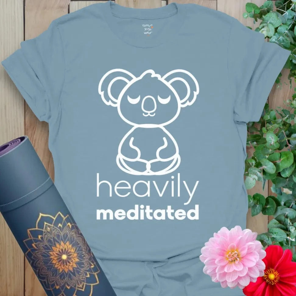 Muted stone blue yoga t-shirt with adorable meditating koala artwork and playful "Heavily Meditated" message.