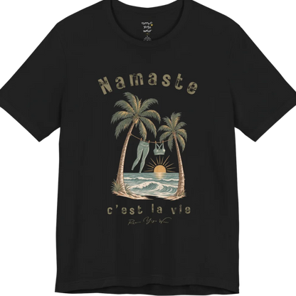 A short sleeved grunge tee with an illustrated scene of two palm trees framing a clothesline with leggings and a sports bra hanging between them, sun setting over waves, text reading "Namaste" and "c'est la vie" — Funny Yoga Shirts collection by Ramro Yoga Wear in Black.