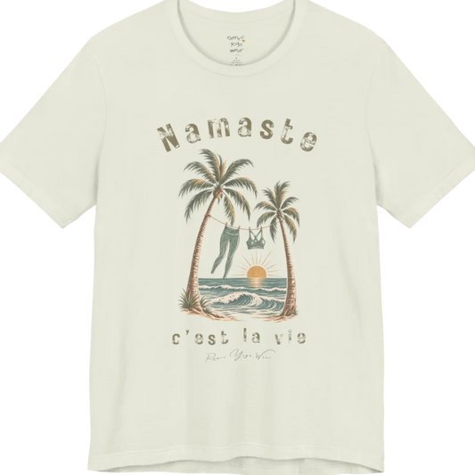 A short sleeved grunge tee with an illustrated scene of two palm trees framing a clothesline with leggings and a sports bra hanging between them, sun setting over waves, text reading "Namaste" and "c'est la vie" — Funny Yoga Shirts collection by Ramro Yoga Wear in Citron.