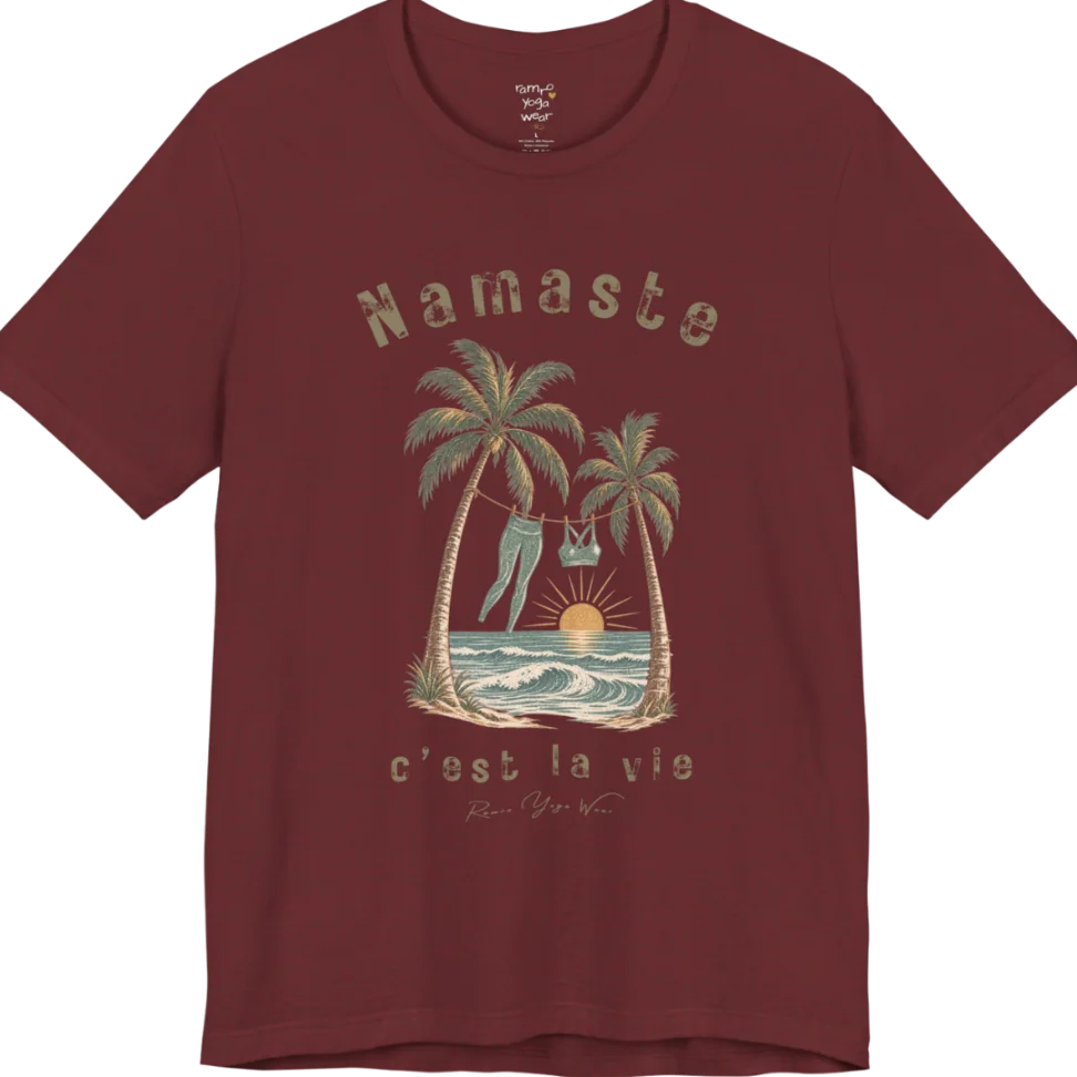 A short sleeved grunge tee with an illustrated scene of two palm trees framing a clothesline with leggings and a sports bra hanging between them, sun setting over waves, text reading "Namaste" and "c'est la vie" — Funny Yoga Shirts collection by Ramro Yoga Wear in Heather Cardinal.