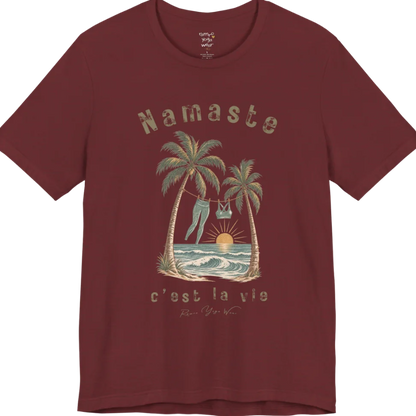 A short sleeved grunge tee with an illustrated scene of two palm trees framing a clothesline with leggings and a sports bra hanging between them, sun setting over waves, text reading "Namaste" and "c'est la vie" — Funny Yoga Shirts collection by Ramro Yoga Wear in Heather Cardinal.