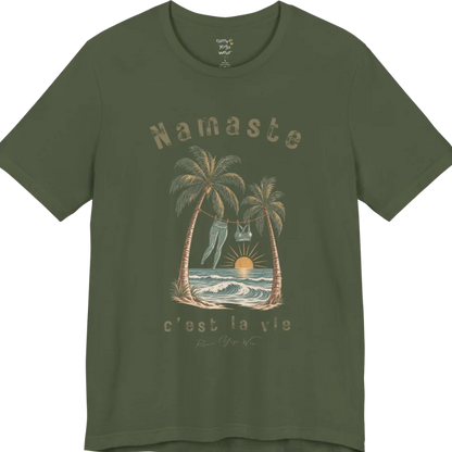 A short sleeved grunge tee with an illustrated scene of two palm trees framing a clothesline with leggings and a sports bra hanging between them, sun setting over waves, text reading "Namaste" and "c'est la vie" — Funny Yoga Shirts collection by Ramro Yoga Wear in Military Green.