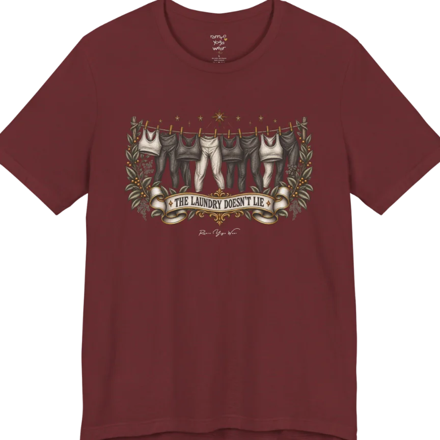 A short sleeved tee. Illustrated clothesline strung with repeating pairs of leggings and tops, framed by botanical leaf sprigs and stars. Laundry T-Shirt flat lay is a Bella+Canvas 3001 and the color is Heather Cardinal.