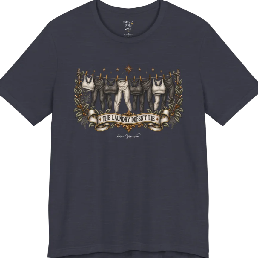 A short sleeved tee. Illustrated clothesline strung with repeating pairs of leggings and tops, framed by botanical leaf sprigs and stars. Laundry T-Shirt flat lay is a Bella+Canvas 3001 and the color is Heather Midnight Blue.