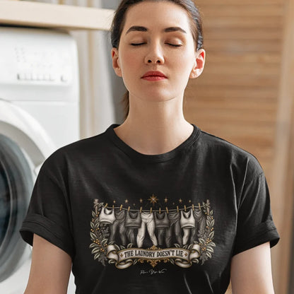 While the washing machine hums in the background a woman is in meditation pose wearing the Laundry T-Shirt. Laundry T-Shirt is a Bella+Canvas 3001 and the color is  Black.