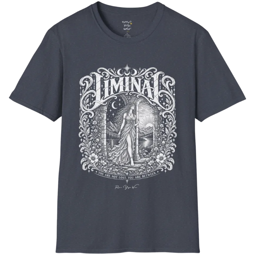 A short sleeved tee called the Liminal T-Shirt, flat lay and a soft cotton shirt. Simply says, 'You are not lost. You are between.' Design highlights ornate white LIMINAL lettering framed by flourishes and wild florals, with a robed figure standing in an arched doorway beneath a crescent moon and stars. Color is Heather Navy.