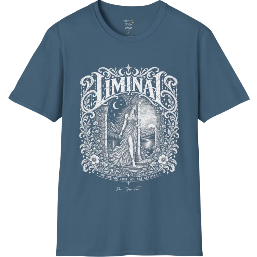 A short sleeved tee called the Liminal T-Shirt, flat lay and a soft cotton shirt. Simply says, 'You are not lost. You are between.' Design highlights ornate white LIMINAL lettering framed by flourishes and wild florals, with a robed figure standing in an arched doorway beneath a crescent moon and stars. Color is Indigo Blue.