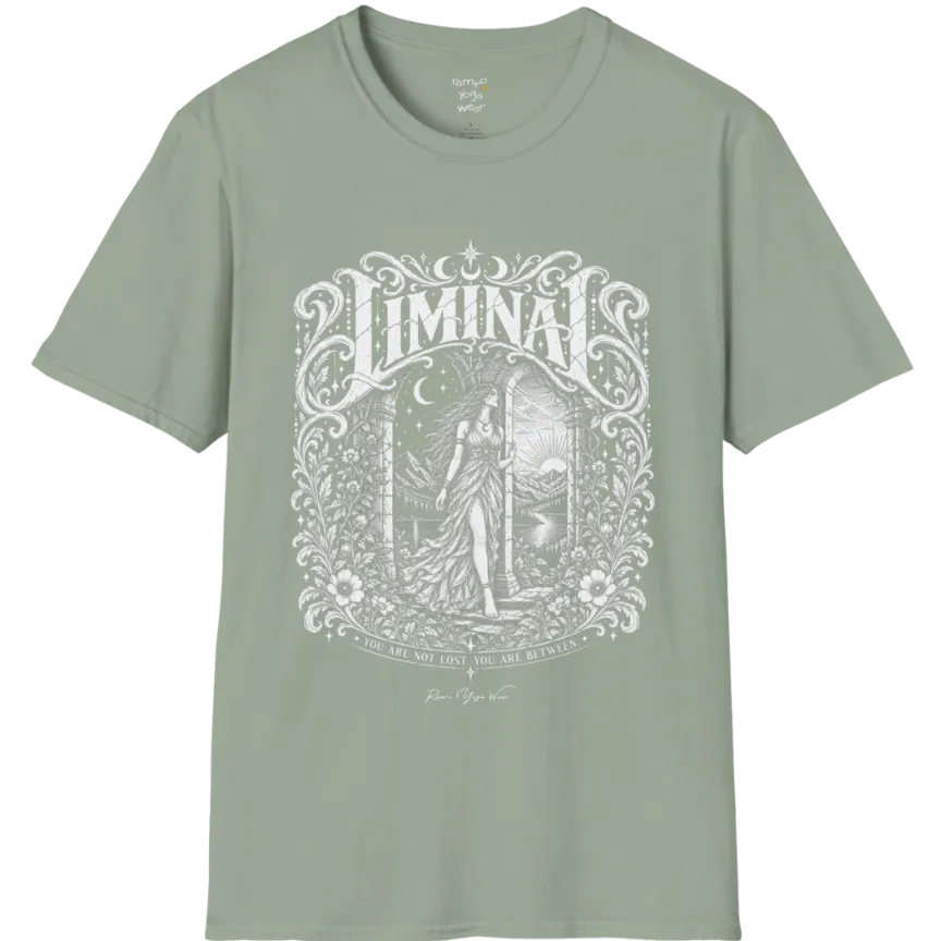 A short sleeved tee called the Liminal T-Shirt, flat lay and a soft cotton shirt. Simply says, 'You are not lost. You are between.' Design highlights ornate white LIMINAL lettering framed by flourishes and wild florals, with a robed figure standing in an arched doorway beneath a crescent moon and stars. Color is Sage.