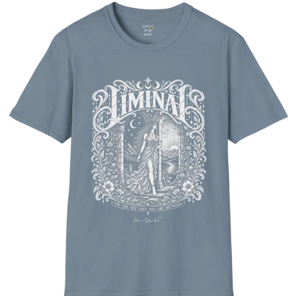 A short sleeved tee called the Liminal T-Shirt, flat lay and a soft cotton shirt. Simply says, 'You are not lost. You are between.' Design highlights ornate white LIMINAL lettering framed by flourishes and wild florals, with a robed figure standing in an arched doorway beneath a crescent moon and stars. Color is Stone Blue.