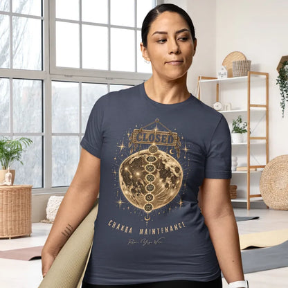 Person wearing the Maintenance T-Shirt in Heather Midnight Navy, indoors holding a yoga mat near a window — Funny Yoga Shirts collection by Ramro Yoga Wear.