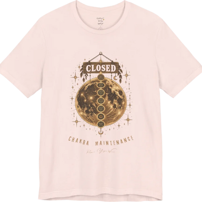 A grunge tee with a "Closed" sign hanging above a full moon, seven chakra symbols stacked down its surface, text reading "Chakra Maintenance" — Funny Yoga Shirts collection by Ramro Yoga Wear in Soft Pink.