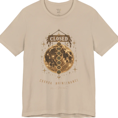 A grunge tee with a "Closed" sign hanging above a full moon, seven chakra symbols stacked down its surface, text reading "Chakra Maintenance" — Funny Yoga Shirts collection by Ramro Yoga Wear in Tan.