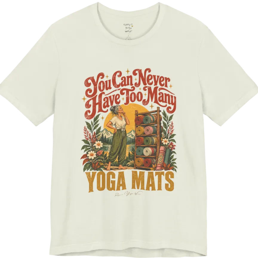 A short sleeved tee called the Mats T-Shirt, flat lay and a soft cotton shirt. Simply says, You Can Never Have Too Many Yoga Mats. Design highlights a silver-haired woman with her hand on her chin, deciding between a wooden rack of rolled yoga mats in rust, mustard, olive, teal and pink, in front of a golden sun, mountains and wildflowers in a retro travel-poster style. Color is Citron.