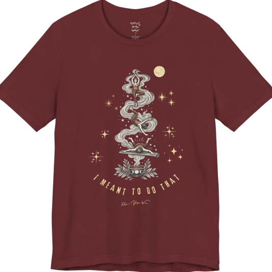 Illustrated figure tumbling through a smoke trail rising from a bowl of smoldering sage, in three yoga pose stages ending in a face-plant on a mat, framed by stars. Meant It T-Shirt flat lay is a Bella+Canvas 3001 and the color is Heather Cardinal.