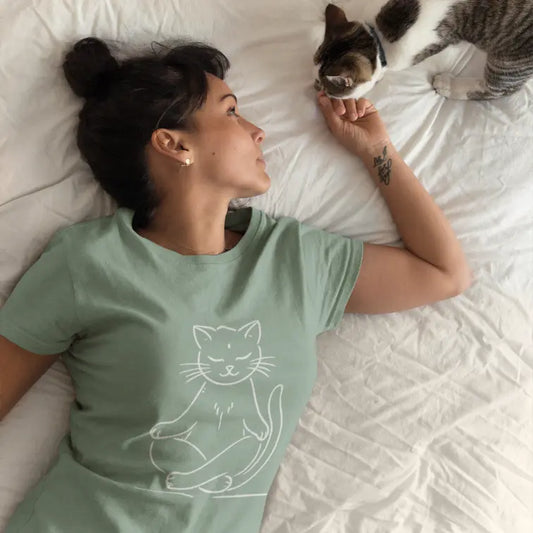 Meditating Cat T-Shirt lifestyle image featuring woman relaxing with cat, showcasing playful mindful yoga lifestyle.