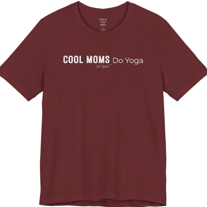 A short sleeved tee called the Moms T-Shirt, flat lay and a soft cotton shirt. Simply says, Cool Moms Do Yoga. Design highlights bold distressed block lettering for Cool Moms beside lighter thin lettering for Do Yoga, with a small script signature underneath. Color is Heather Cardinal.